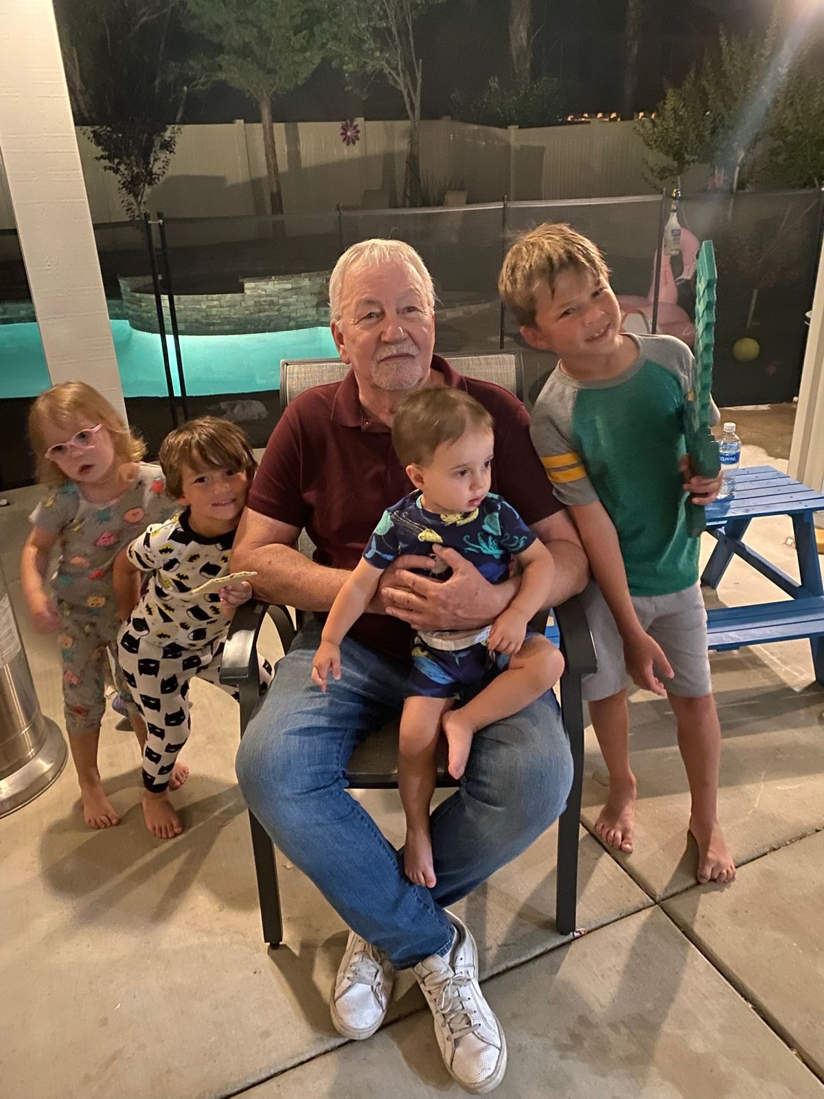 Robert with four grandchildren by the pool