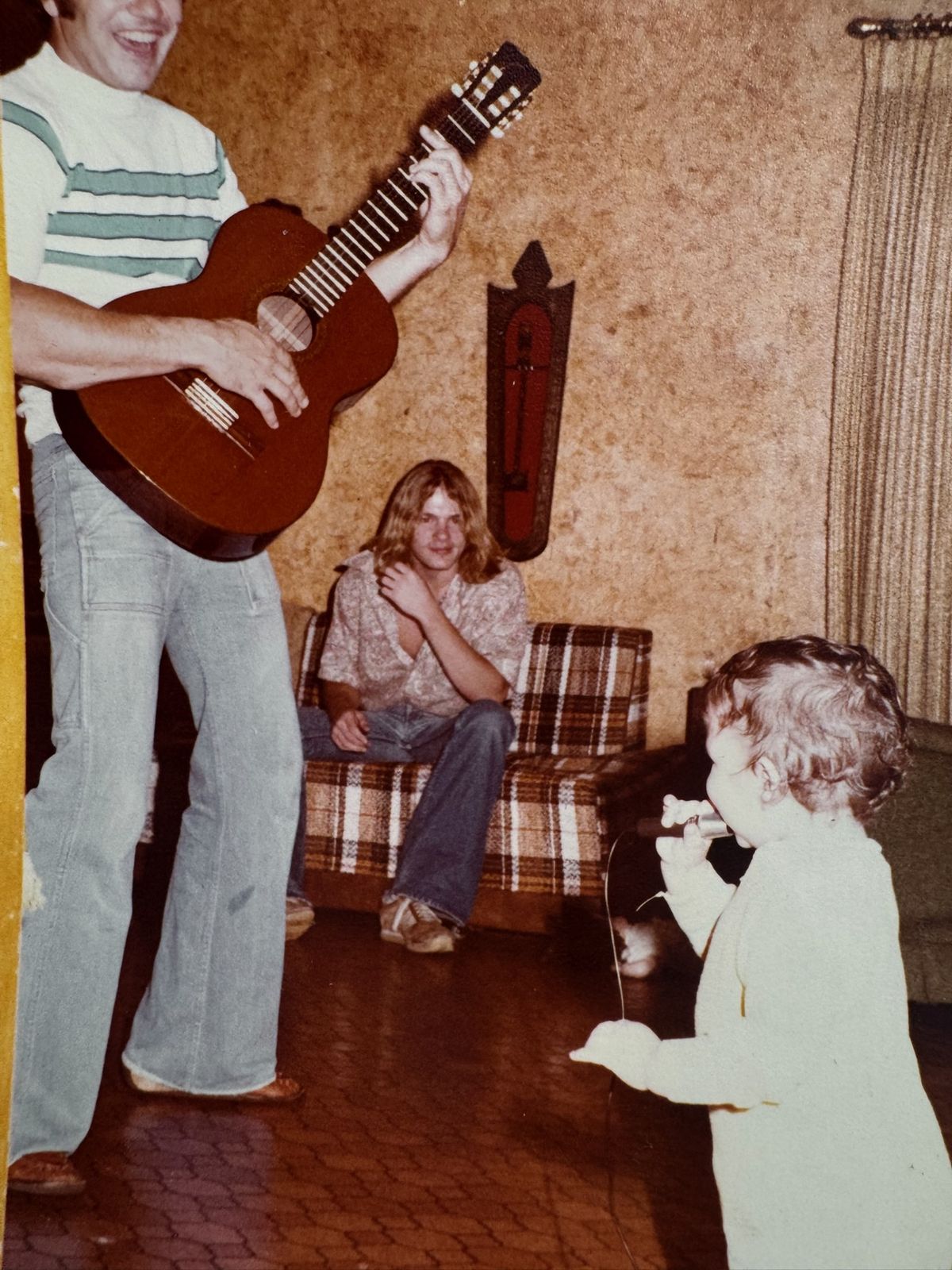 Robert playing guitar at home