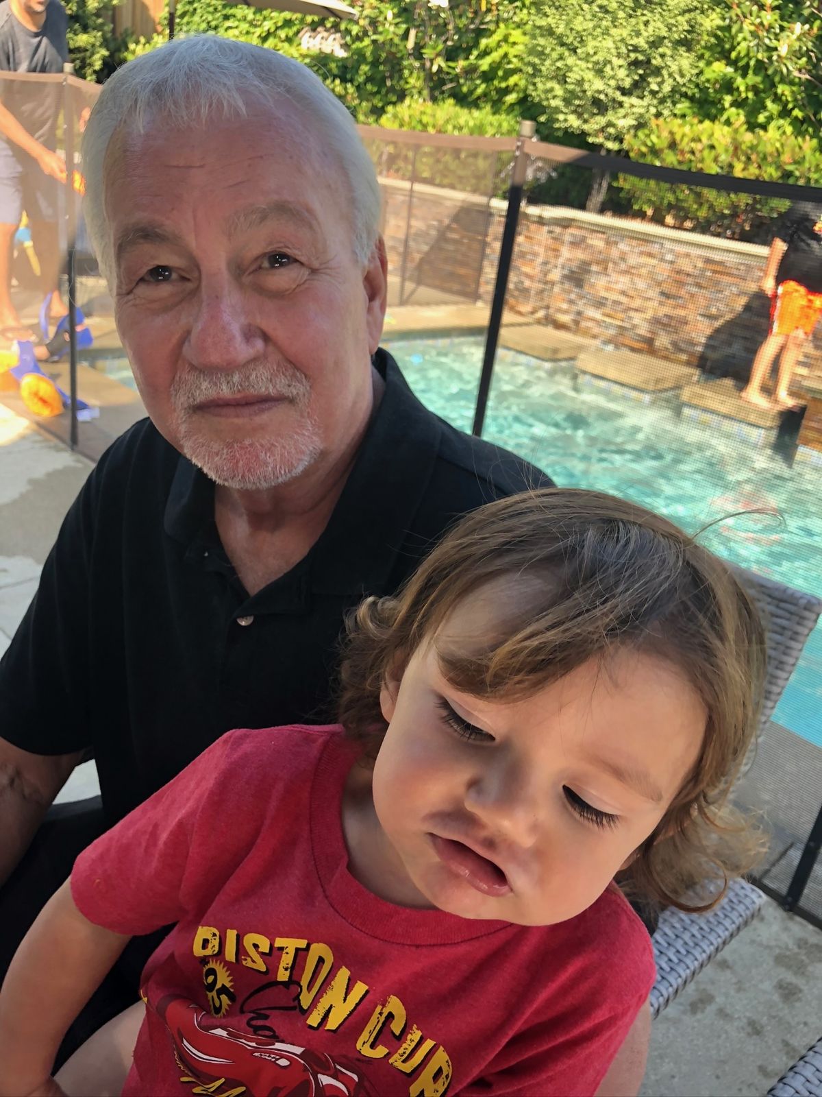 Robert with a grandson by the pool