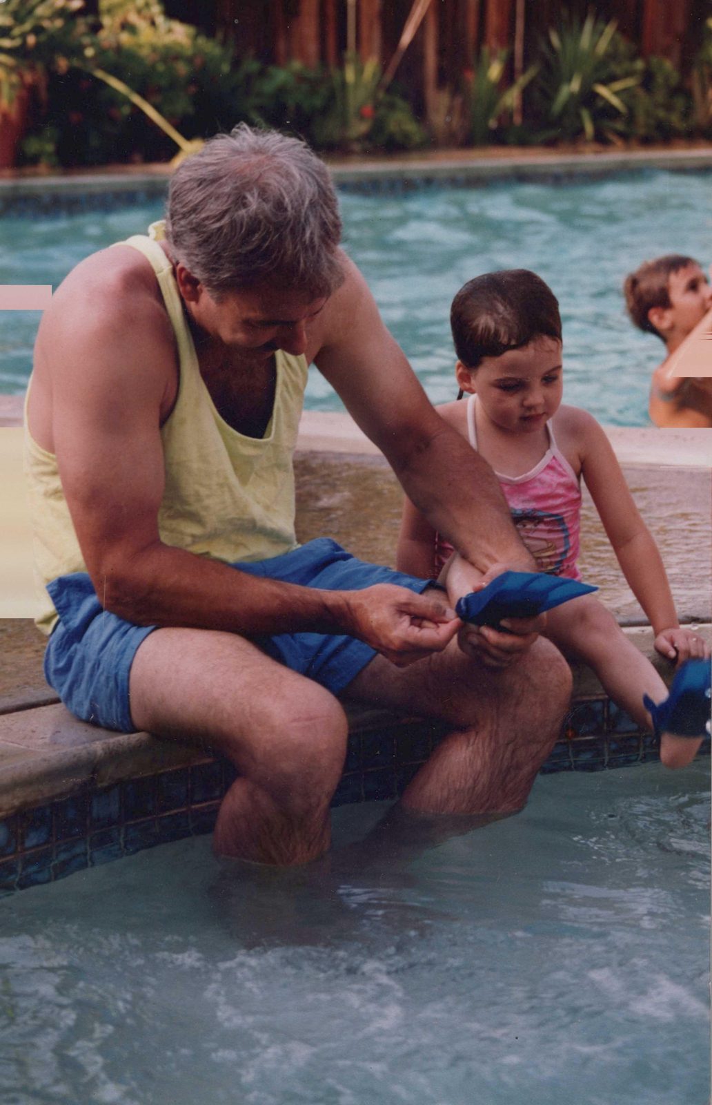 Robert Harmon at the pool with a child