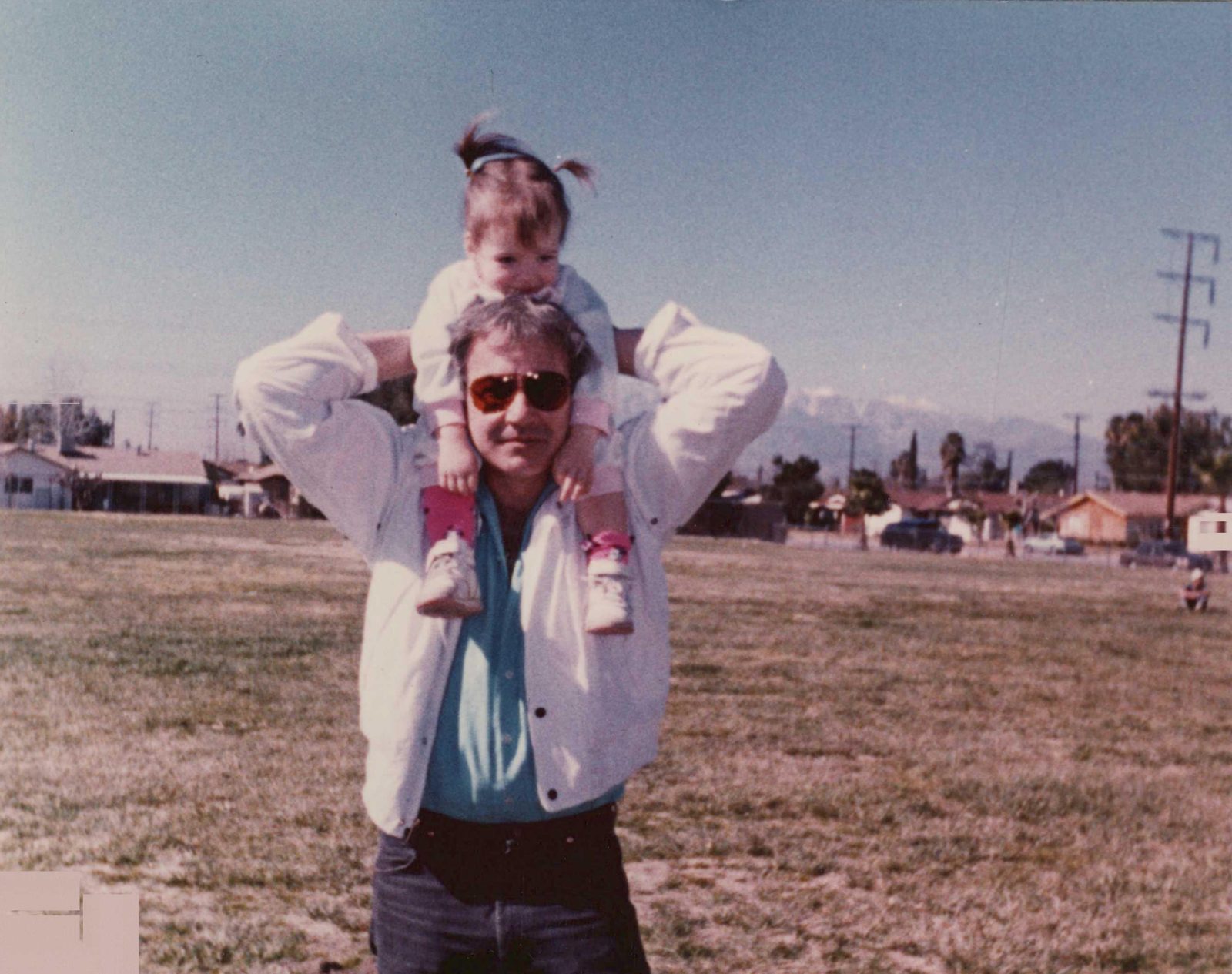 Robert Harmon with a child on his shoulders