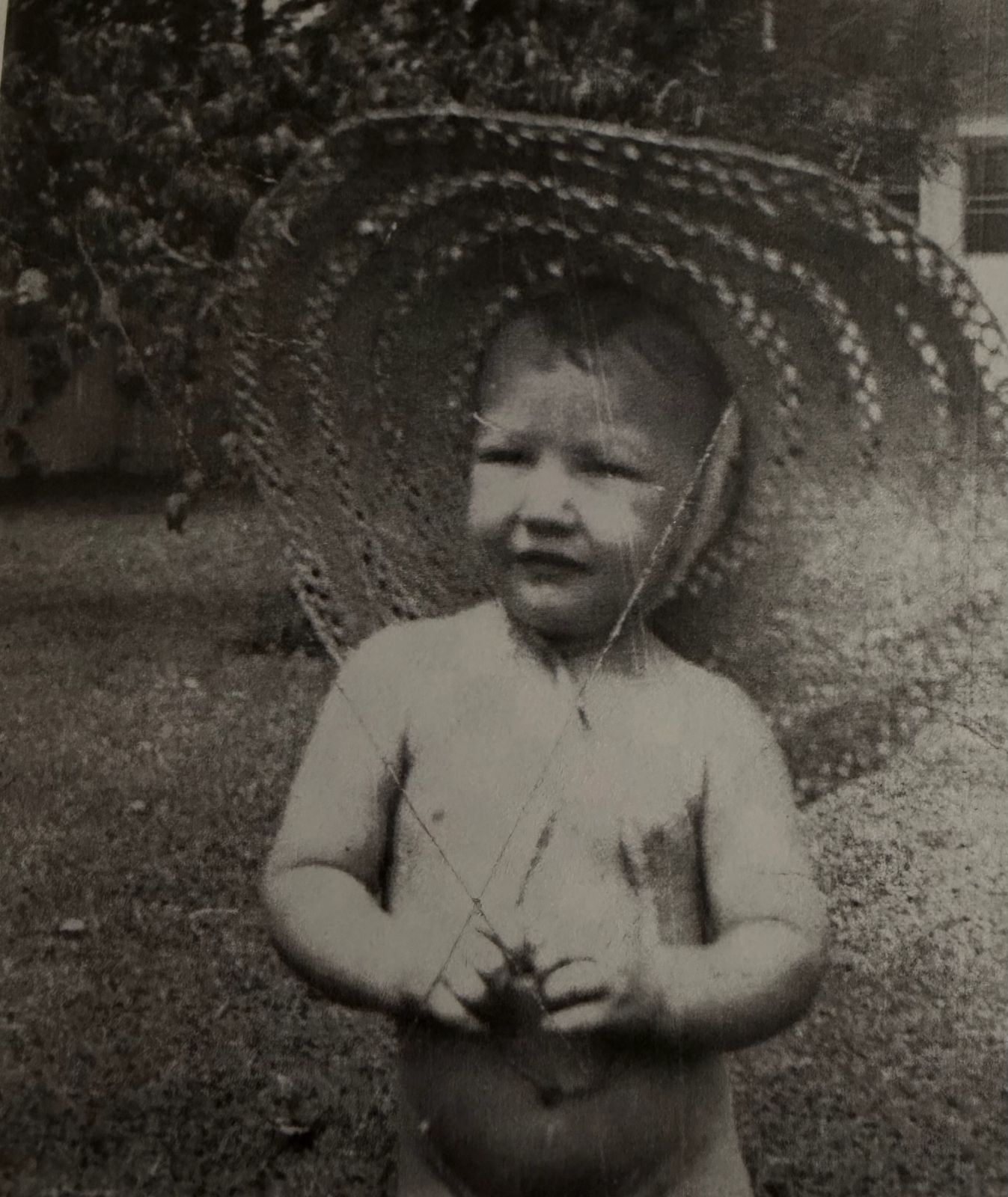 Robert as a toddler in a straw hat